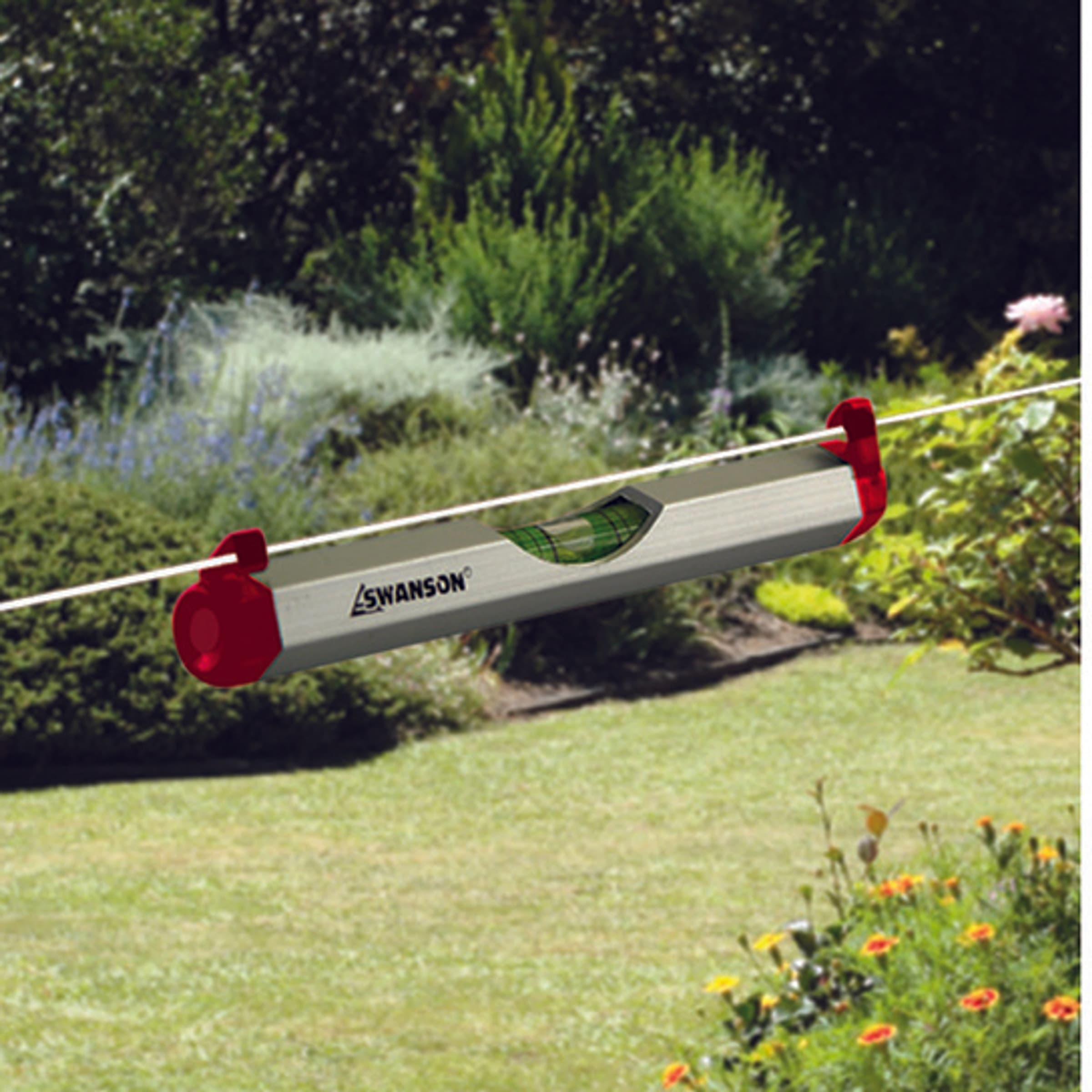 The Swanson line level hung from a string line over a lawn.