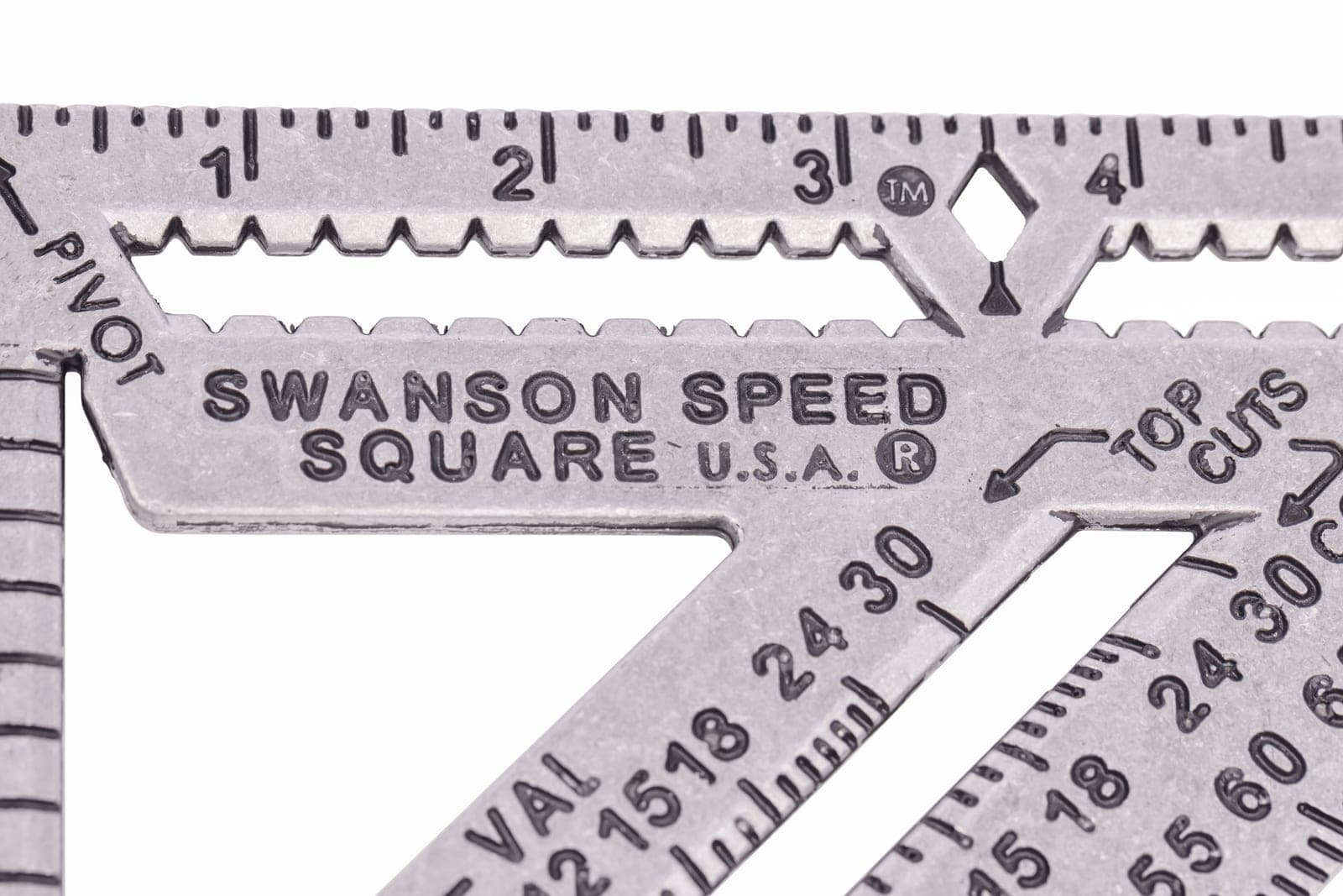 Macro close-up of the front face of a Swanson Speed® Square PRO showing the 2× longer scribe bar, the 1-4 in. graduations, the SWANSON SPEED SQUARE U.S.A. brand mark, and the Diamond™ cut-out at the 3½ in. mark.