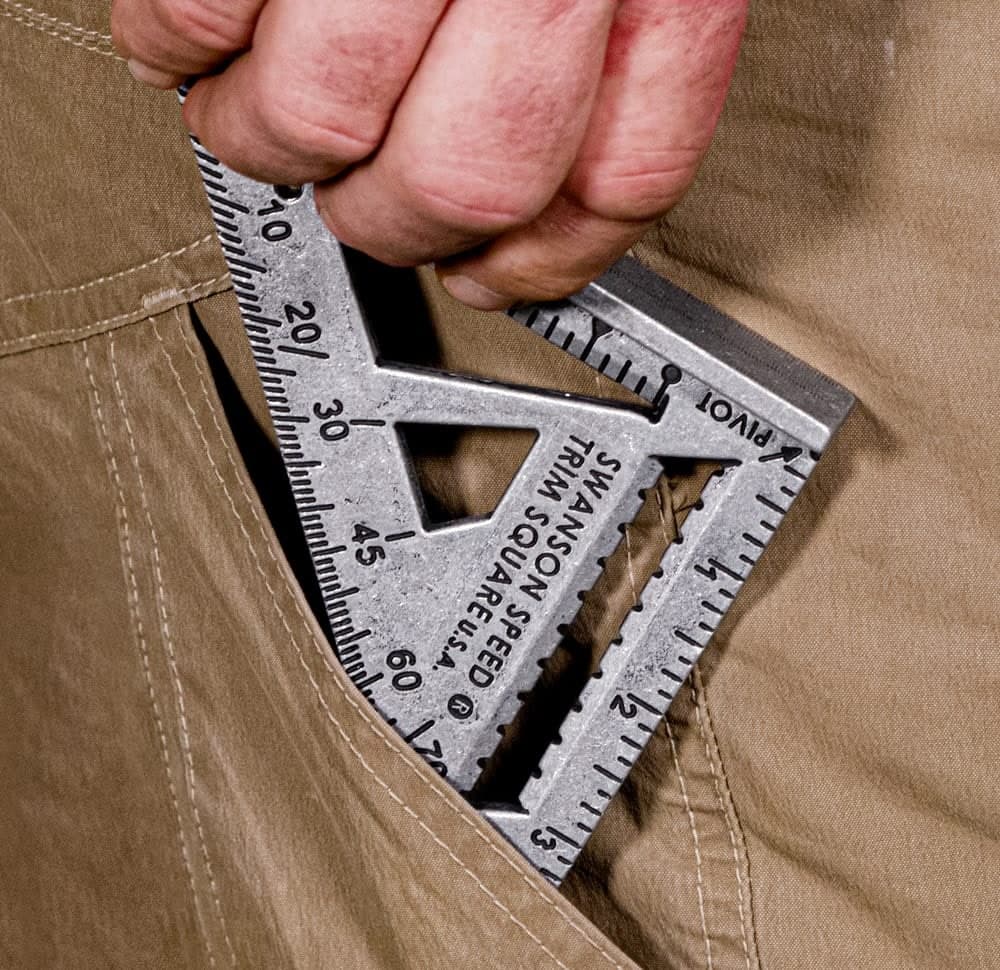 A Swanson Trim Speed® Square next to a tape measure, showing its pocket-sized 4½ in. form factor.
