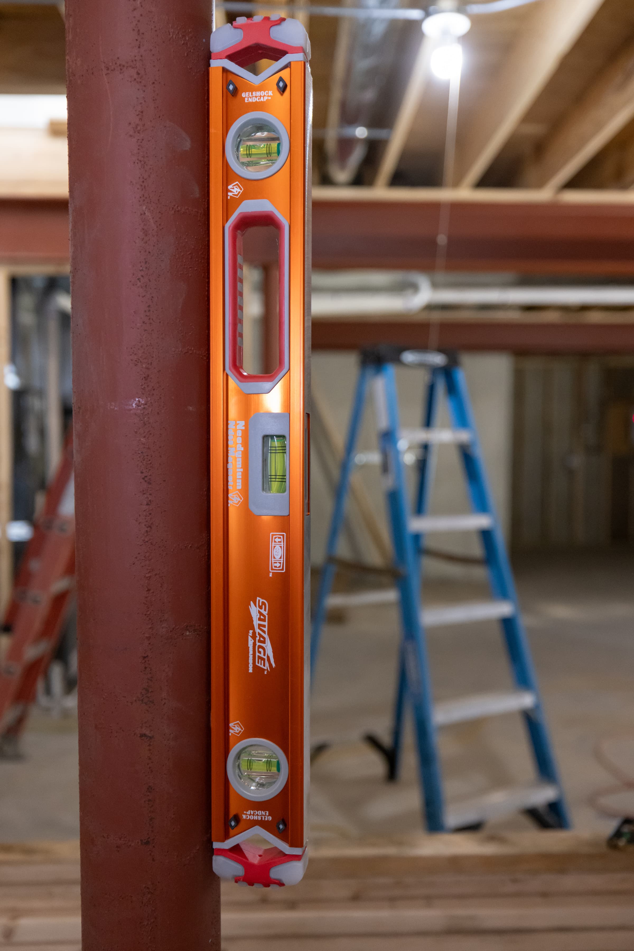 A trades pro using the SVB24M Magnetic Box Beam Level for layout work.