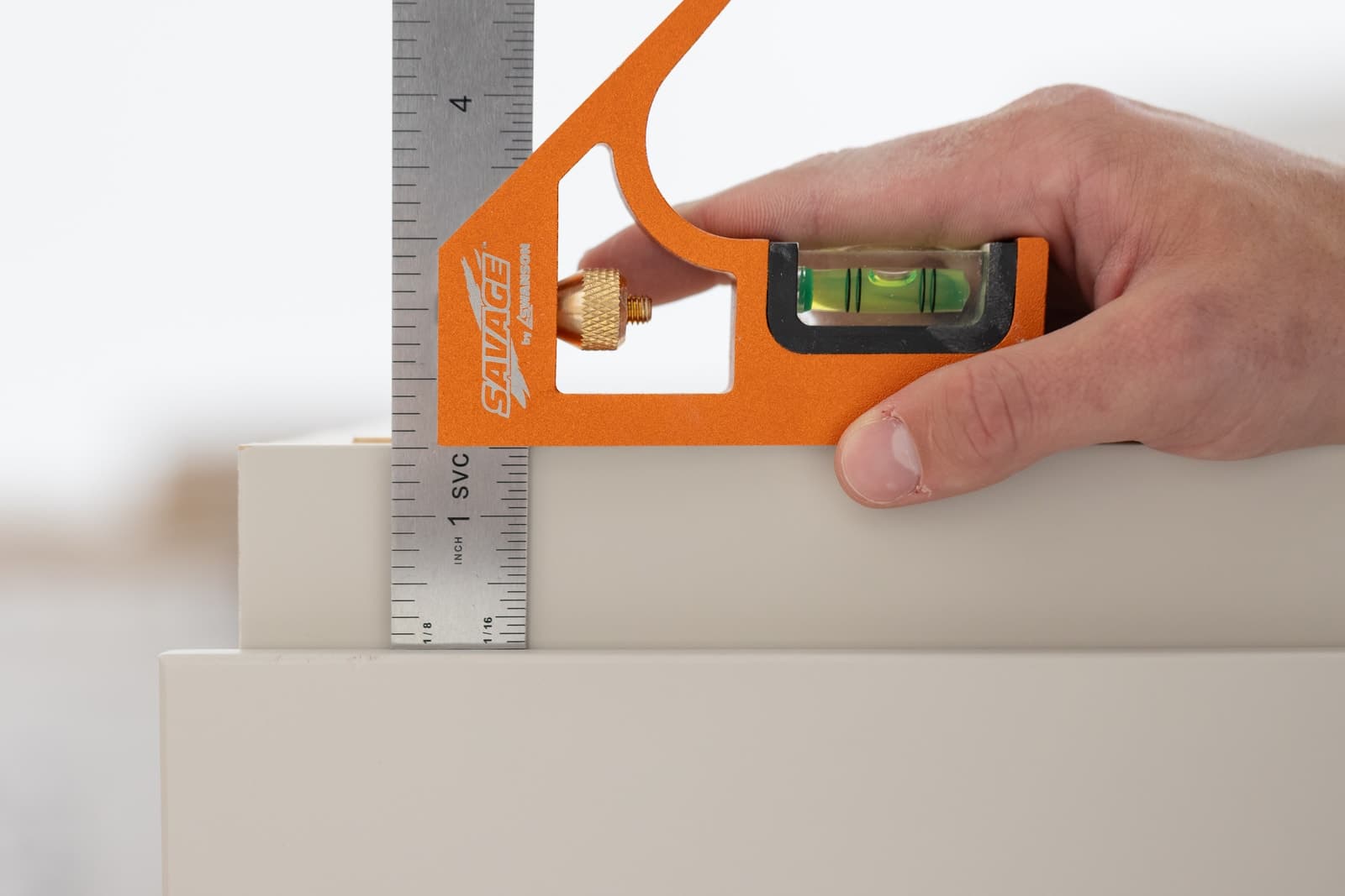 A carpenter using the Swanson SAVAGE® SVC133 Combination Square on a layout in the field.
