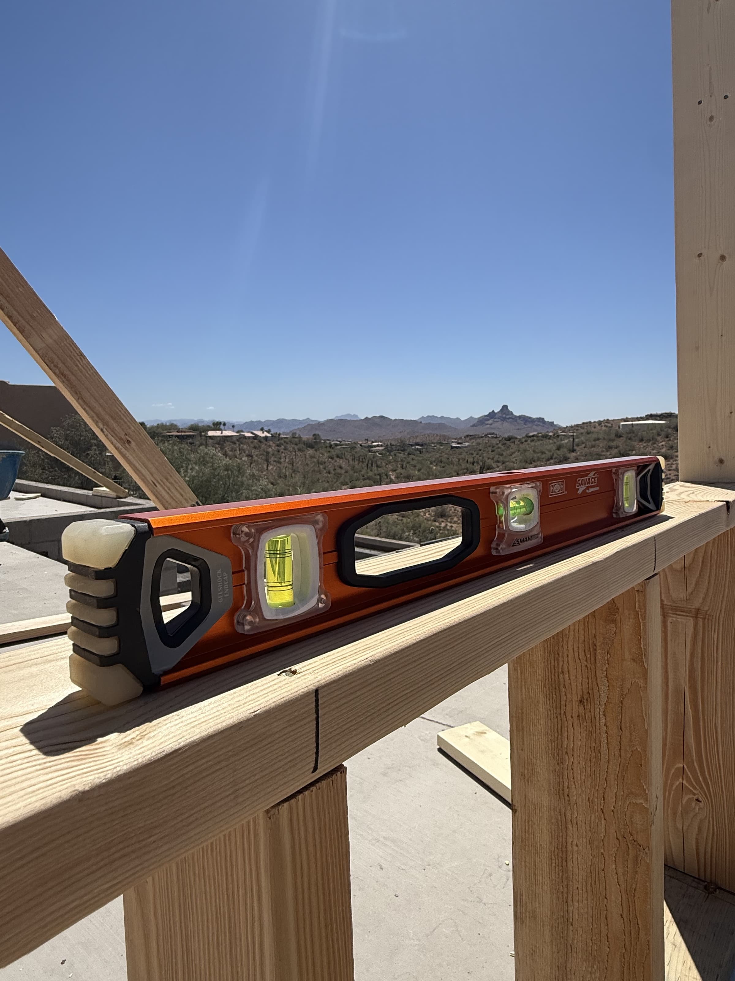 A trades pro using the SVI240 SAVAGE® I-Beam Level on a job site.