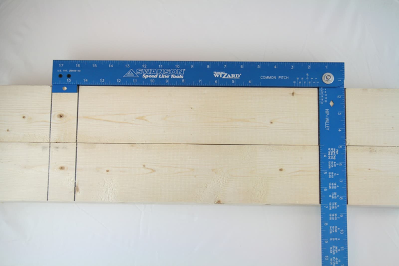 A framer using the Swanson Framing Wizard® on a job site to lay out a rafter.