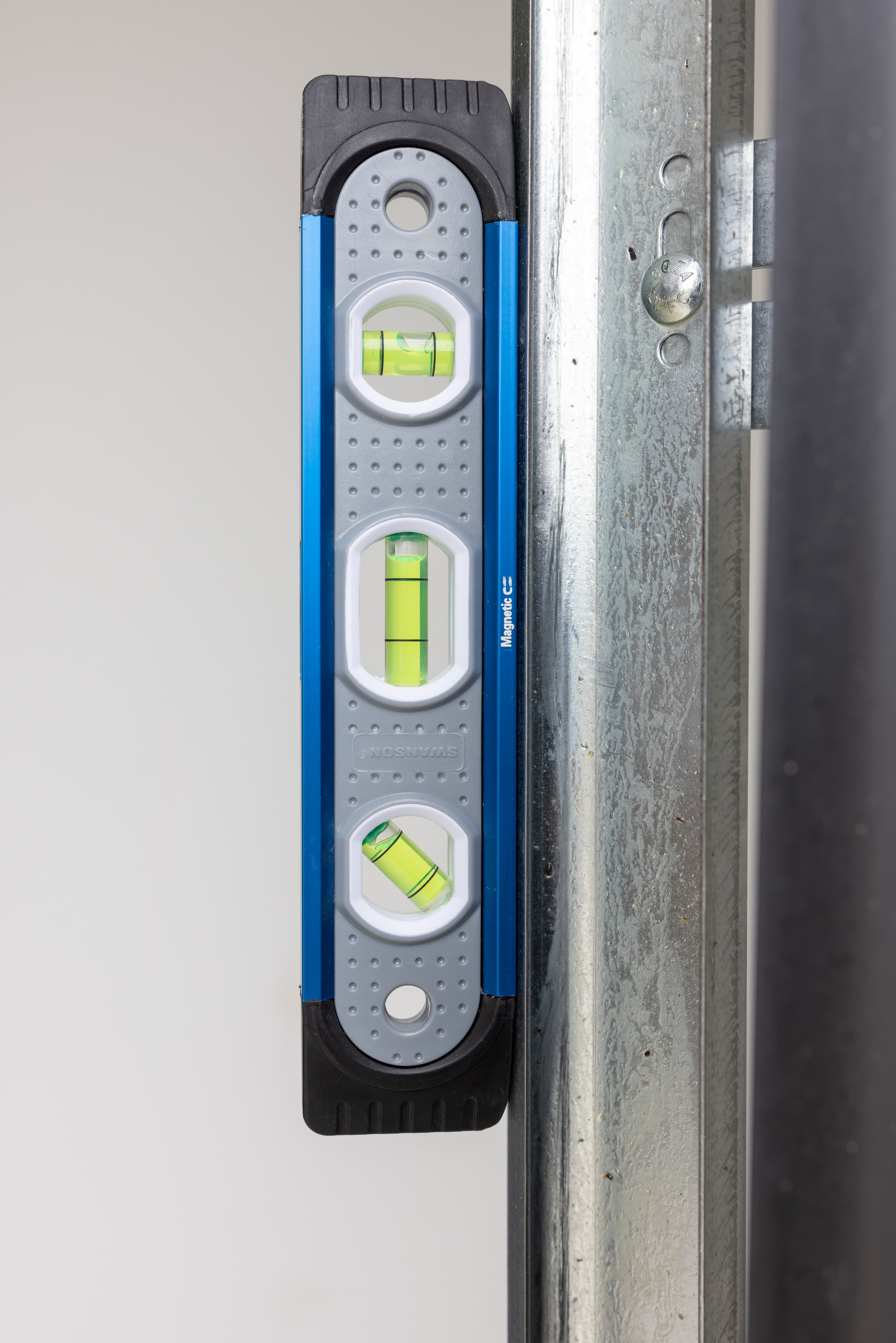 The Swanson TL009M Magnetic Shock-Resistant Torpedo Level held by its magnets on a steel stud.