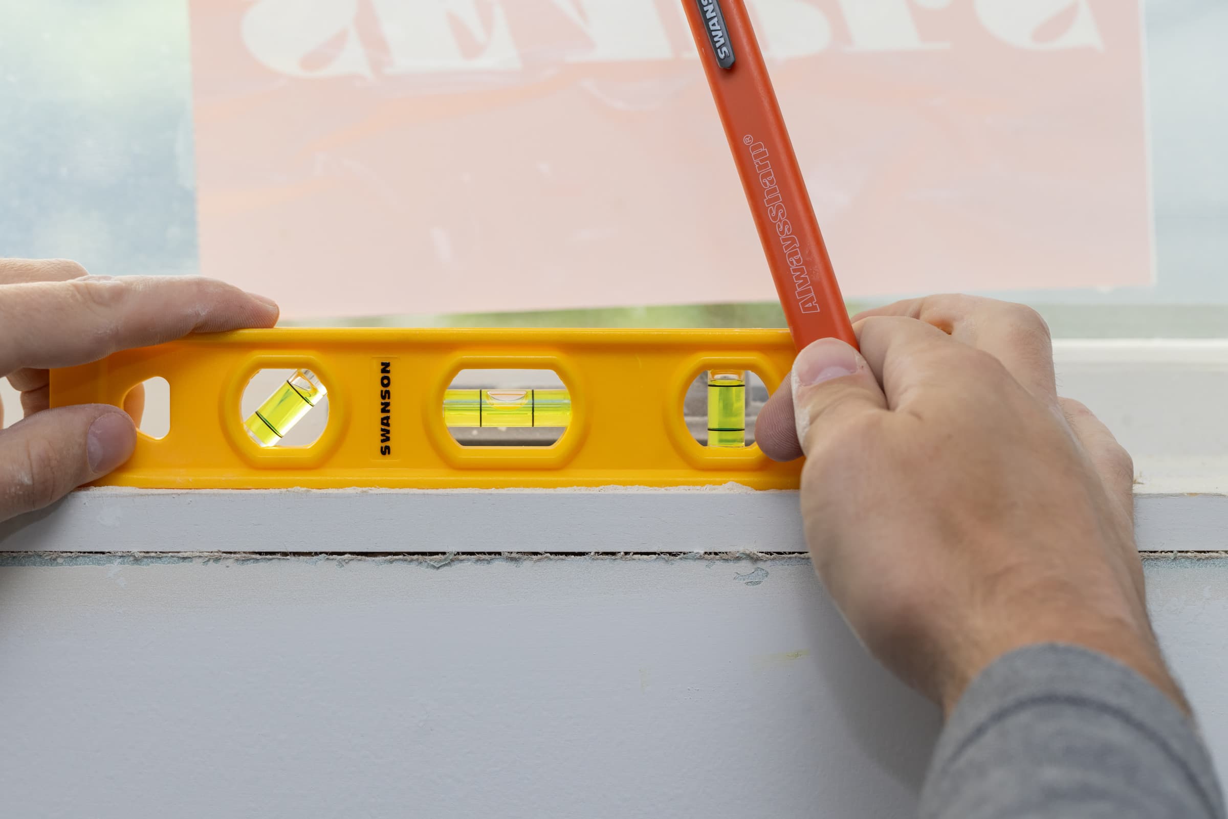 A trades pro using the Swanson Speedlite® torpedo level on pipe or round stock, V-groove edge seated.