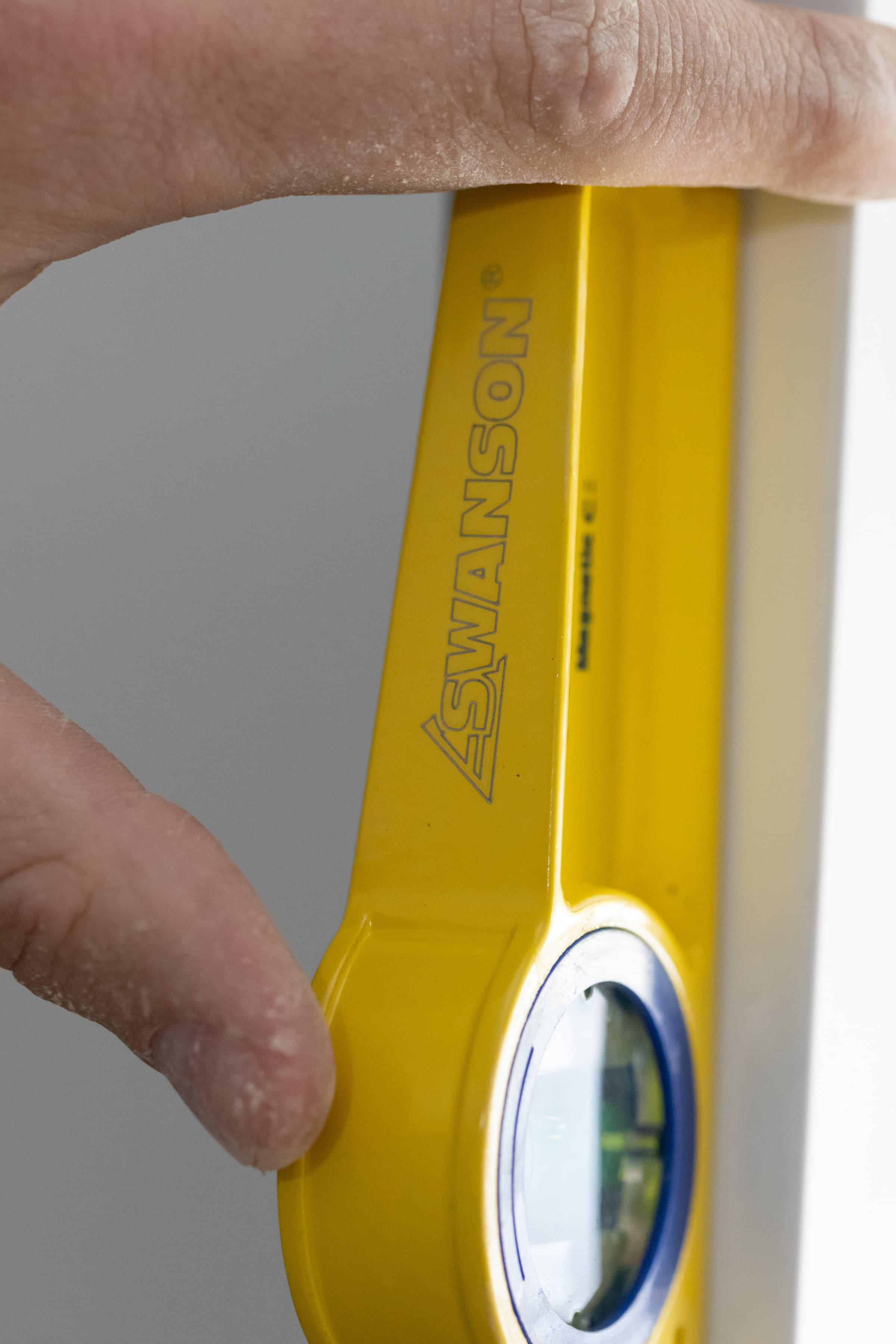 Pro-Cast torpedo level in use on a concrete or masonry form for pitch and grade reading.