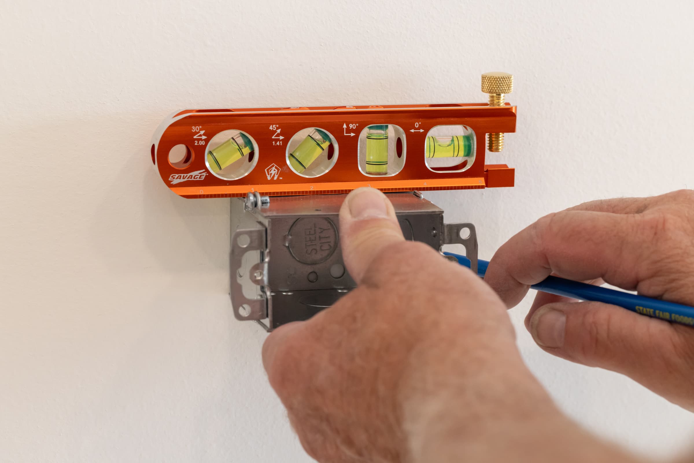 A trades pro using the Swanson Lil Savage® Torpedo Level on the job site.