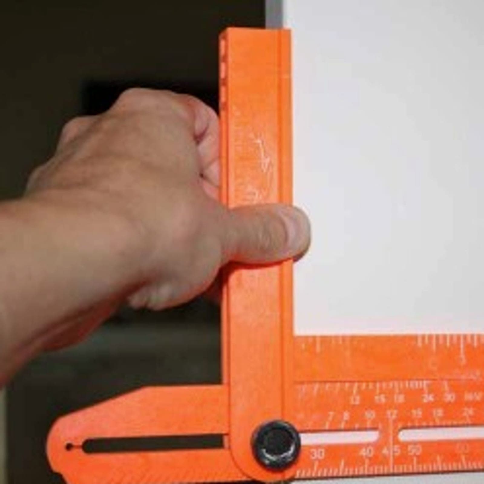A Swanson Speed Bevel® being used on a door frame to scribe a trim layout line.