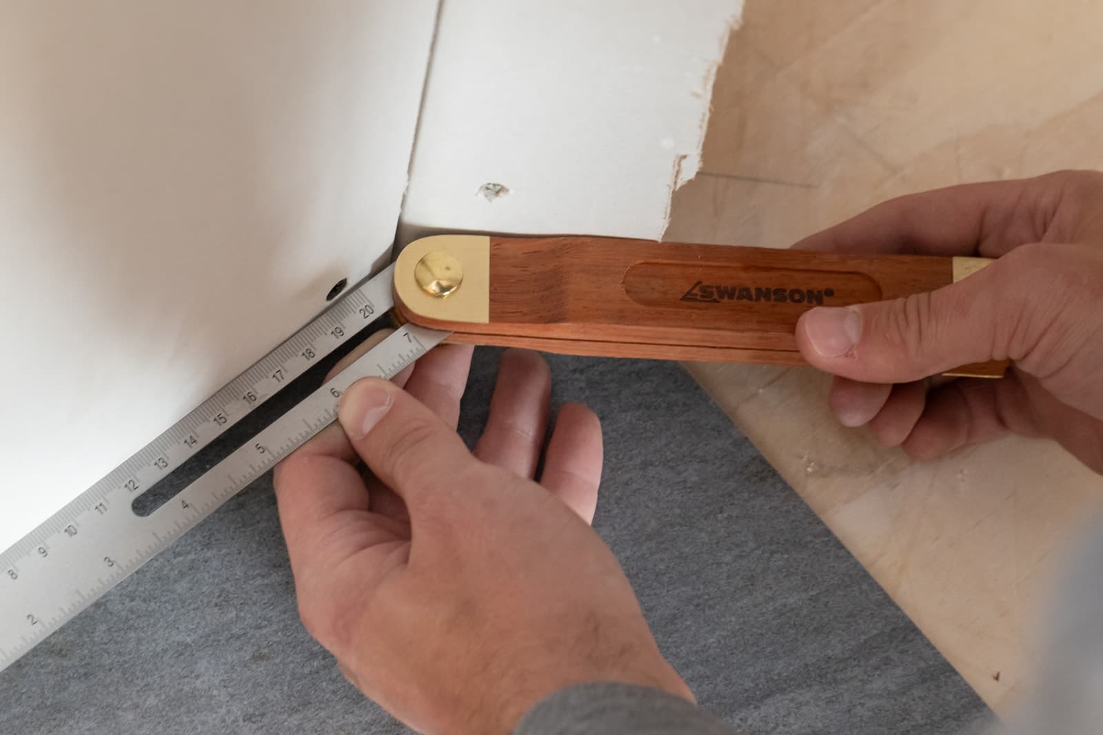 A woodworker using the Swanson TS149 to transfer an angle off a piece of stock at the bench.