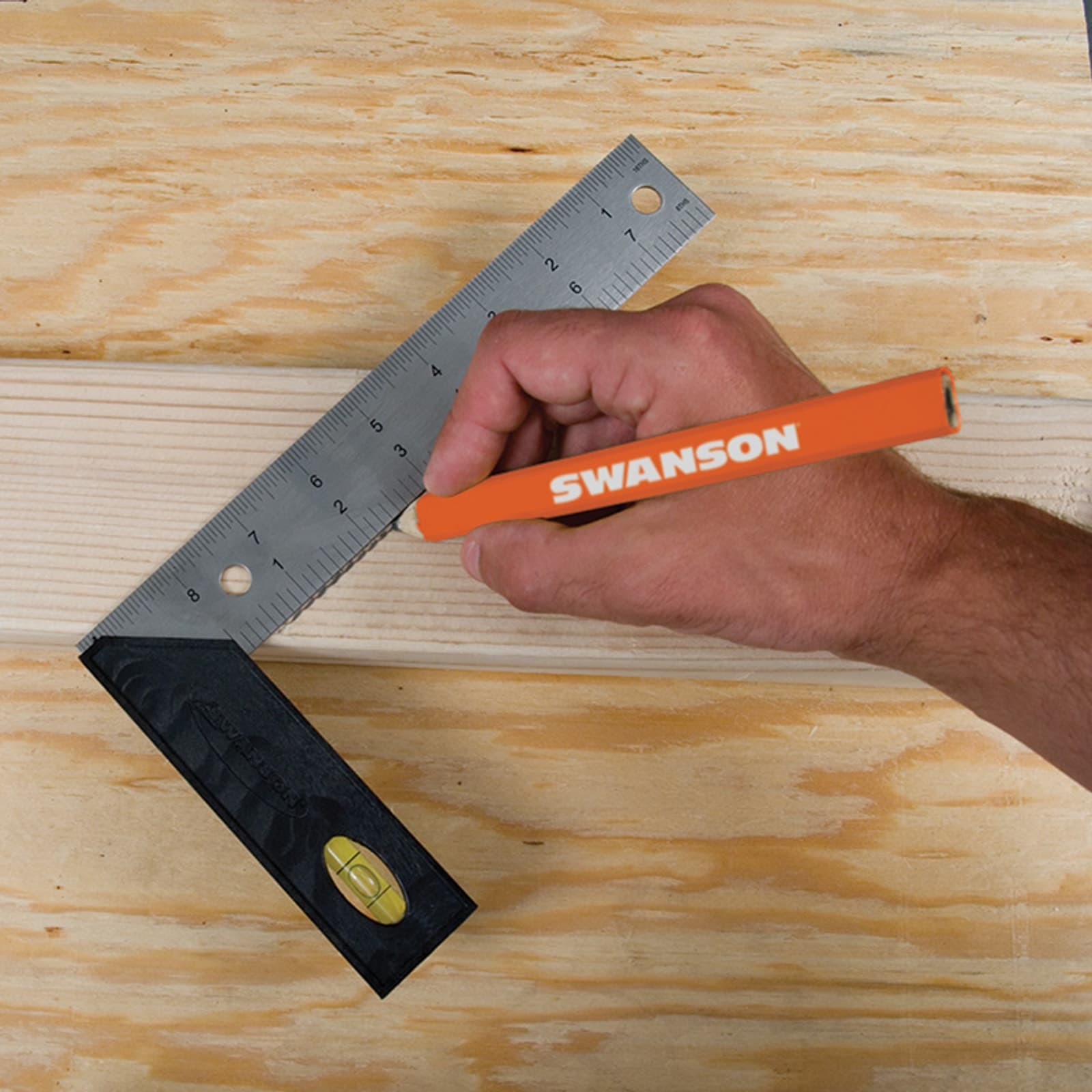 A carpenter using the Swanson TS151 to mark a square layout on a piece of stock at the bench.