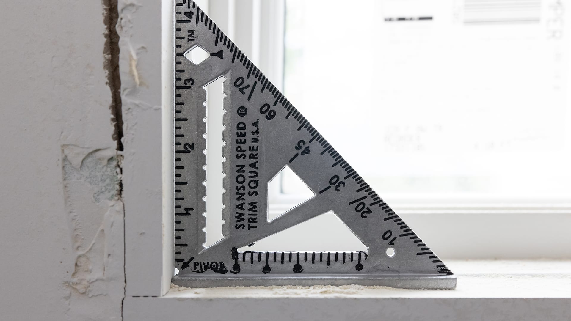 The Swanson Trim Speed® Square on a window sill, mid-trim work.